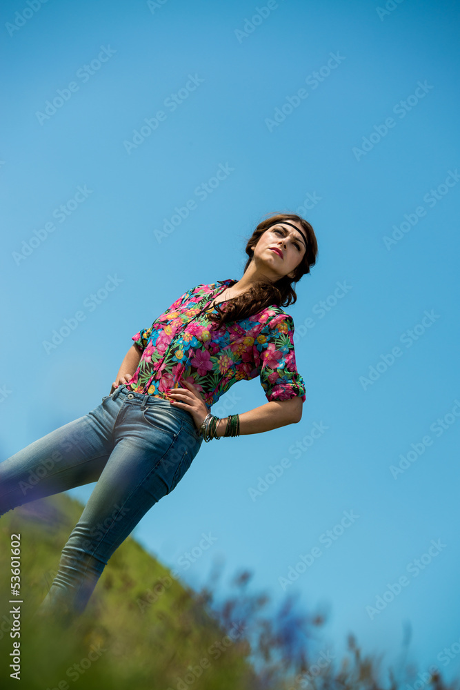 beautiful woman in jeans standing on the grass beautiful woman in jeans standing on the grass