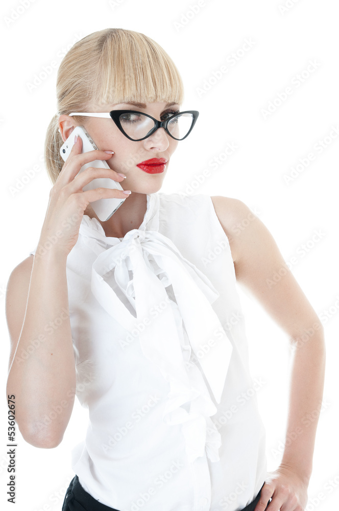 Sexy blonde business executive using smartphone.