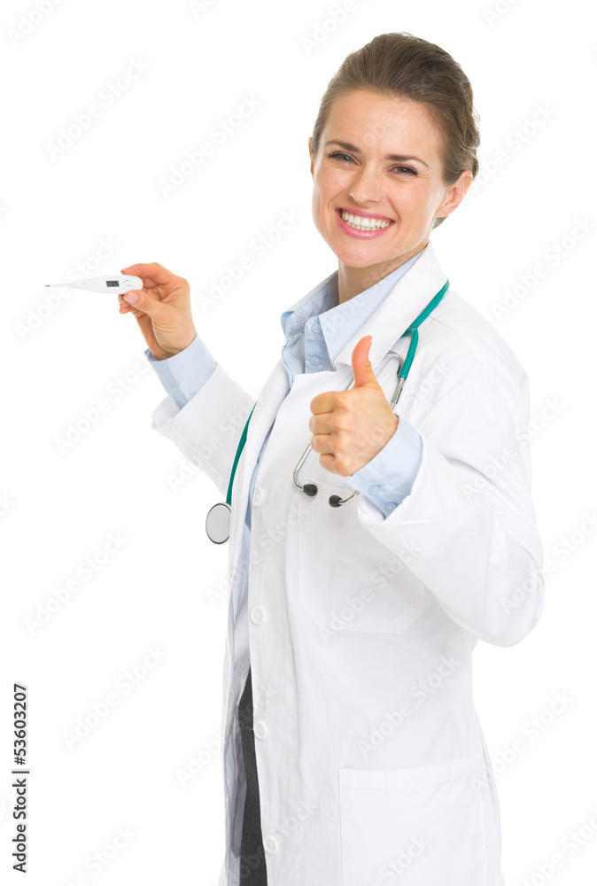 Smiling doctor woman holding thermometer and showing thumbs up Smiling doctor woman holding thermometer and showing thumbs up
