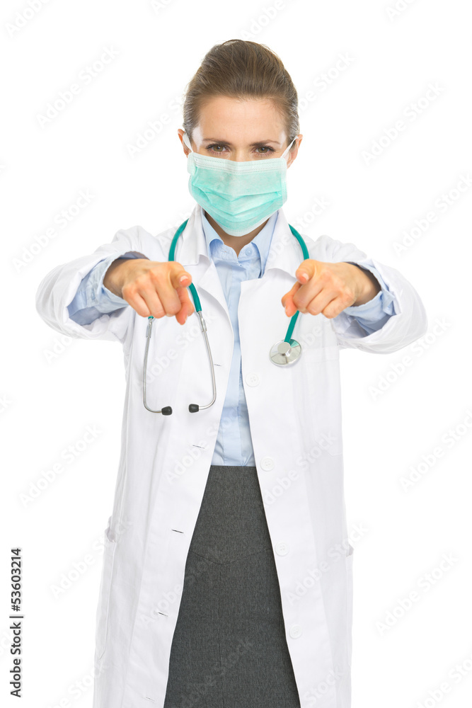 Doctor woman in mask pointing in camera Doctor woman in mask pointing in camera