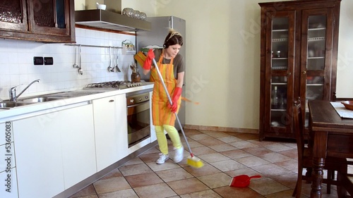 happy housewife cleaning and dancing