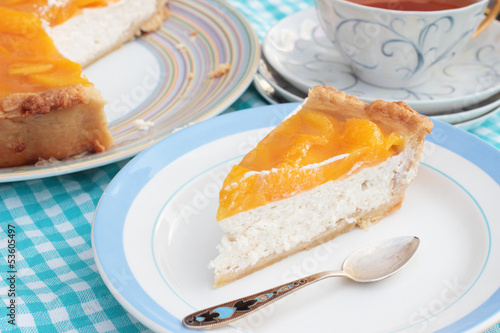 Obraz na plátně Piece of tasty peach cheesecake with agar jelly on a plate with