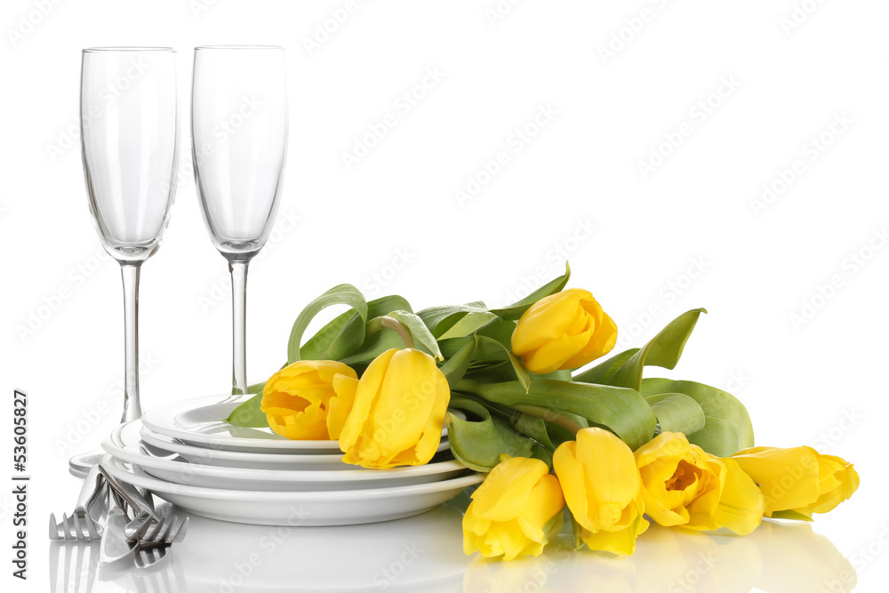 Yellow tulips and utensils for serving isolated on white