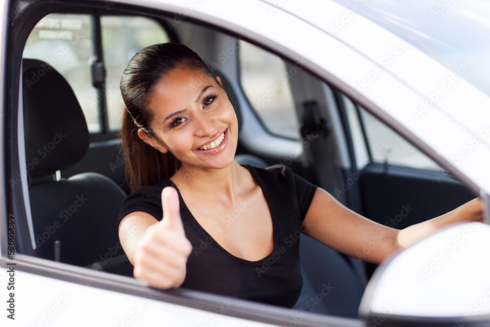 businesswoman giving thumb up inside new car