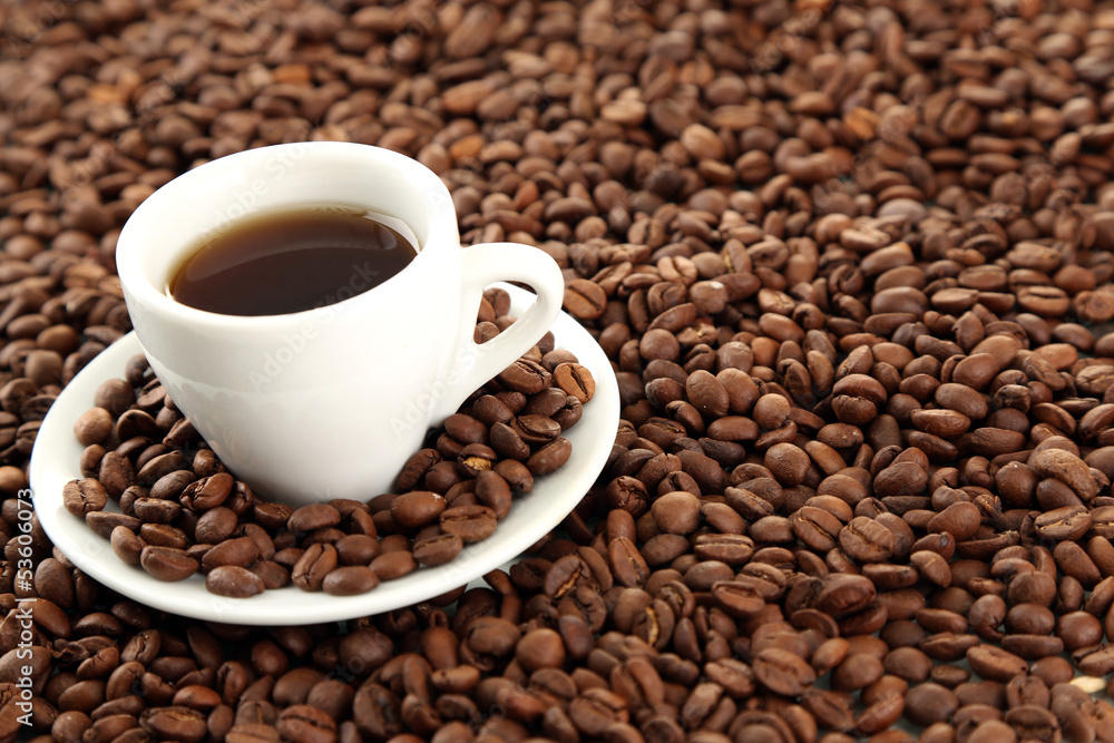 Cup of coffee on coffee beans background Cup of coffee on coffee beans background