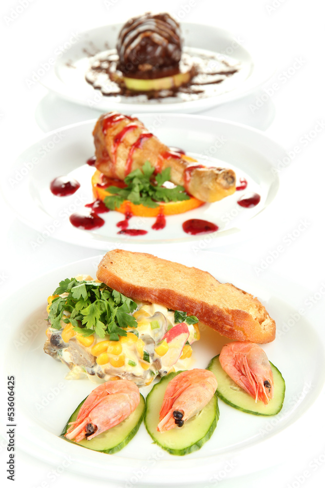 Small portions of food on big white plates isolated on white Small portions of food on big white plates isolated on white