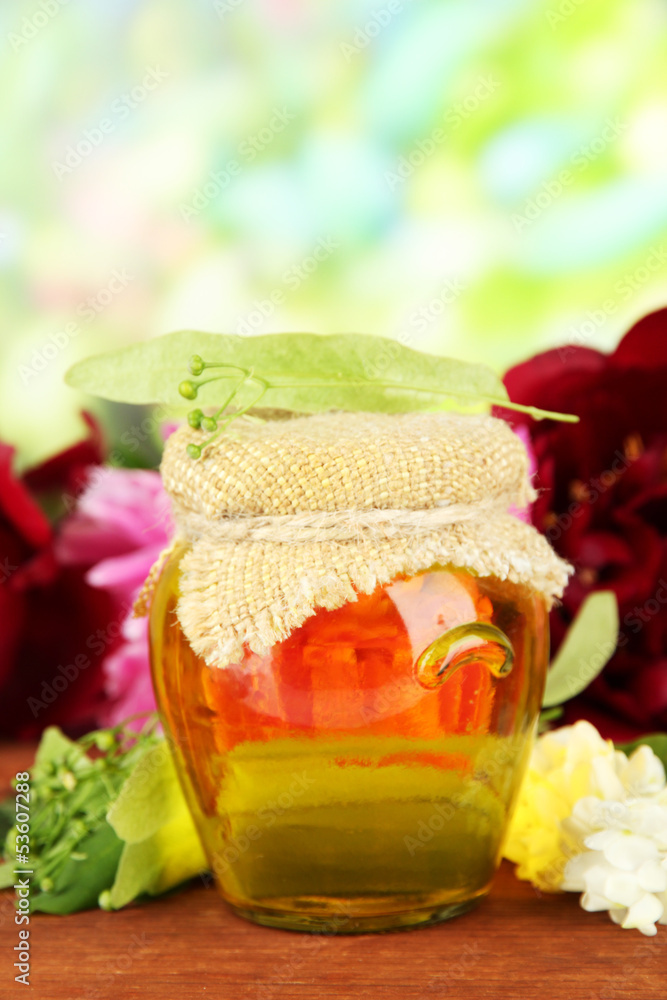 Jar of honey with flowers of lime, acacia, peony Jar of honey with flowers of lime, acacia, peony