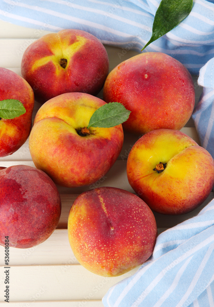 Peaches on napkin on wooden table Peaches on napkin on wooden table