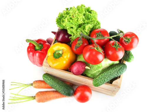 Fresh vegetables in wooden box on grey background