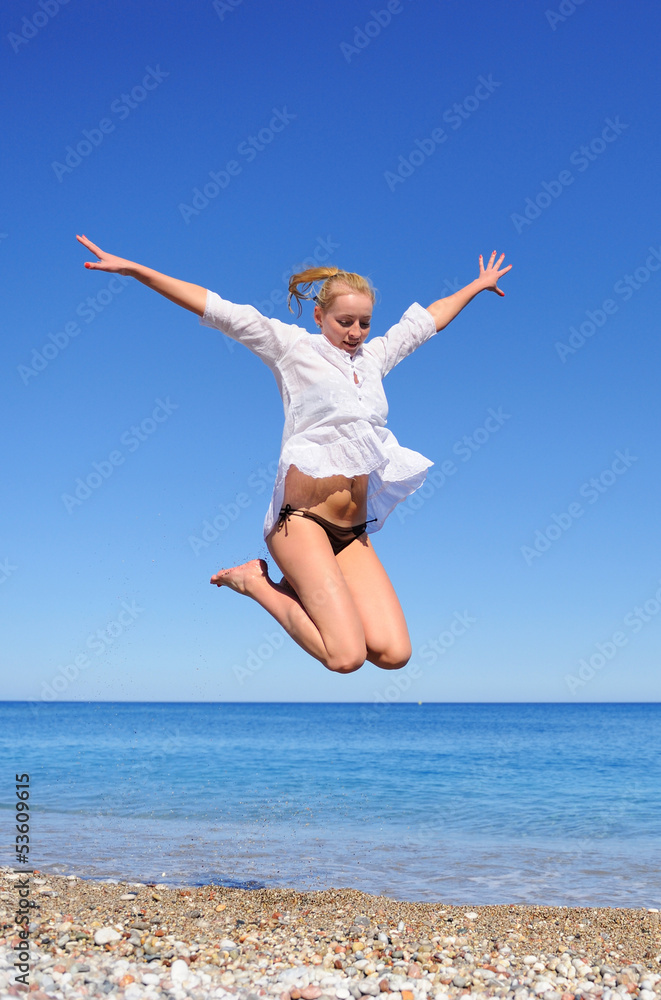 Beautiful Girl Jumping on The Beach