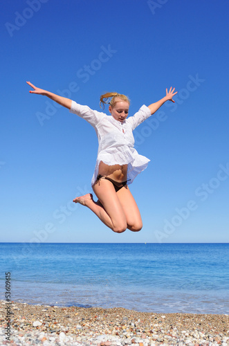 Beautiful Girl Jumping on The Beach