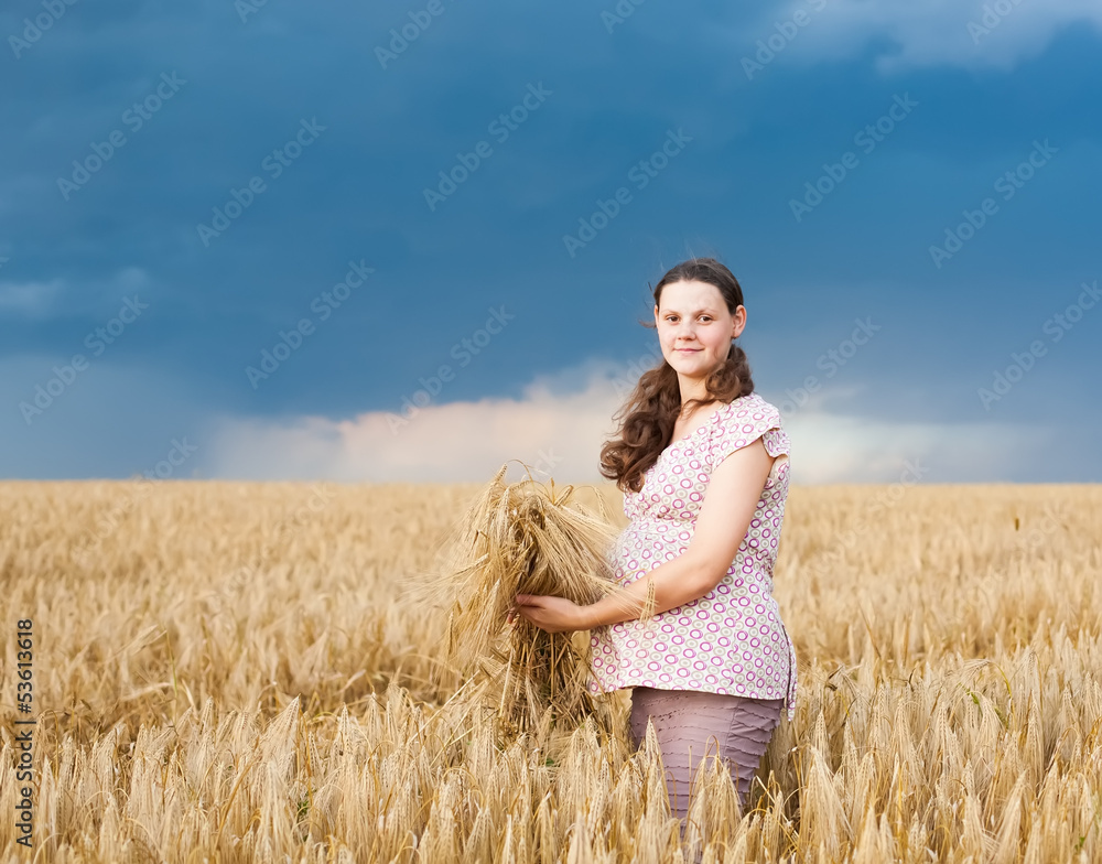 Young pregnant woman on wheat field Young pregnant woman on wheat field
