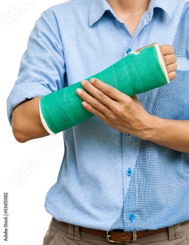 Green cast on an arm of a women isolated