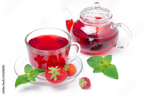 kettle and a cup of red tea with strawberries and mint isolated