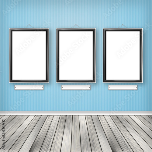 Three empty frames on a wall