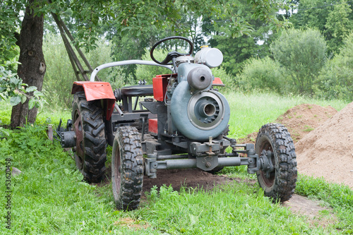 Self-made tractor under apple tree
