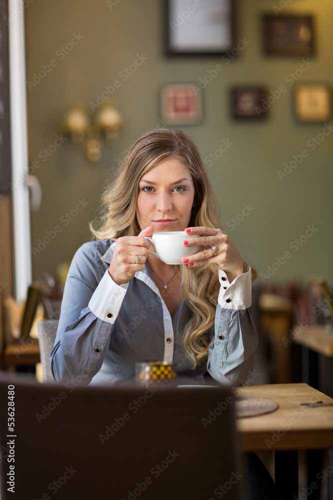 Young Woman Drinking Coffee At Cafe Young Woman Drinking Coffee At Cafe