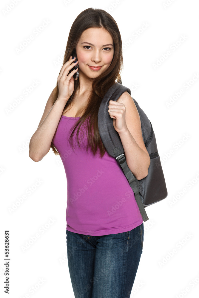 Female with backpack talking on cell phone Female with backpack talking on cell phone
