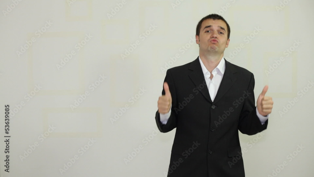 Ecstatic confident businessman gesturing and showing thumbs up Ecstatic confident businessman gesturing and showing thumbs up