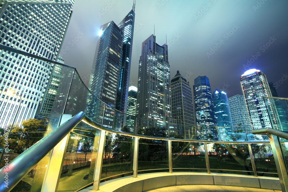 Obraz premium Looking up at the modern office buildings at night in Shanghai