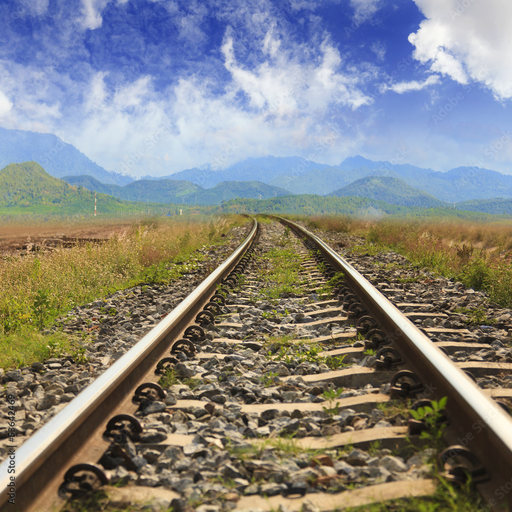 Fototapeta premium Railway through the mountains with blue sky