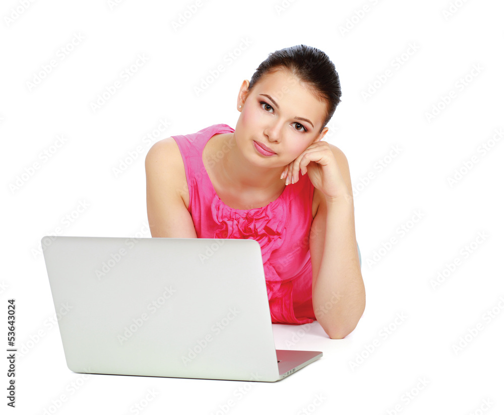 Portrait of beautiful young woman lying on floor with a laptop Portrait of beautiful young woman lying on floor with a laptop