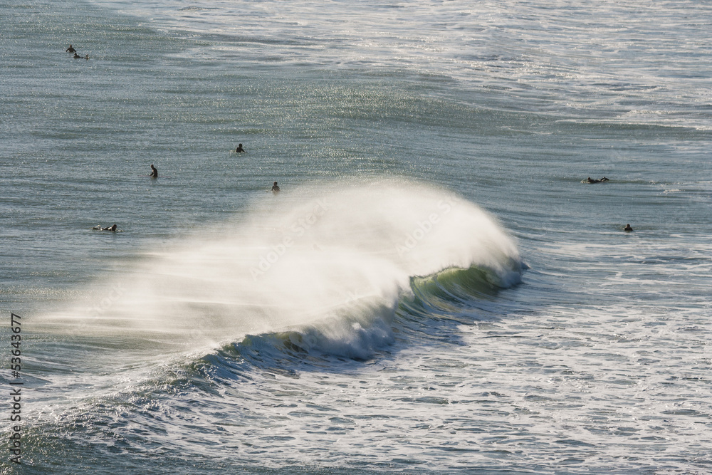 breaking wave with surfers