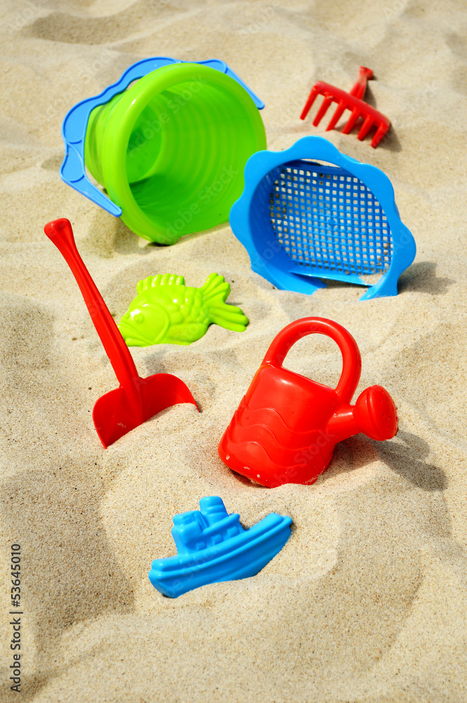 Plastic children toys on the sand beach Plastic children toys on the sand beach
