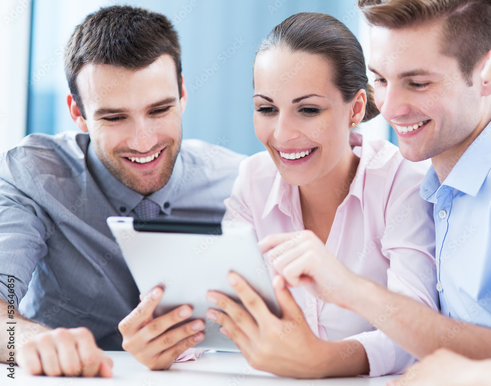 Business people looking at digital tablet Business people looking at digital tablet