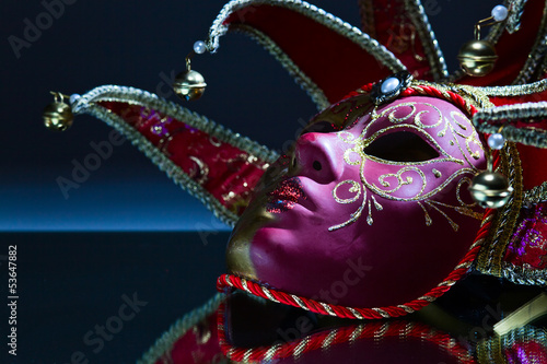 mask with bells on a mirror table