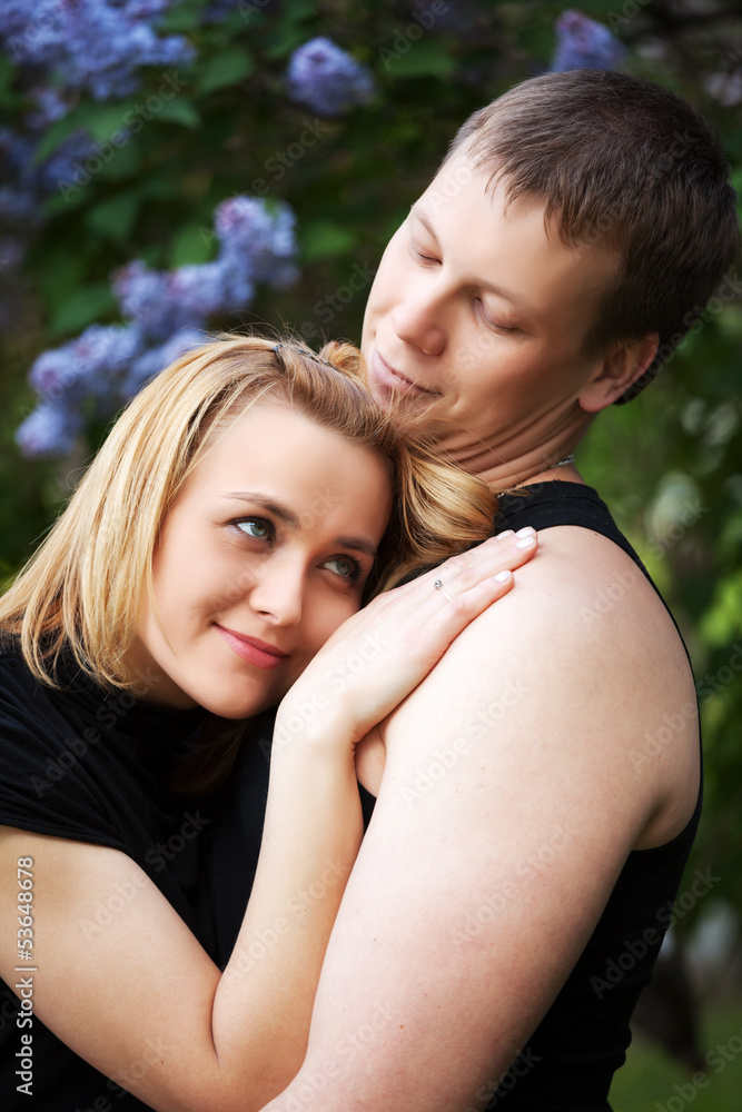 Fototapeta premium Happy young couple in a spring garden