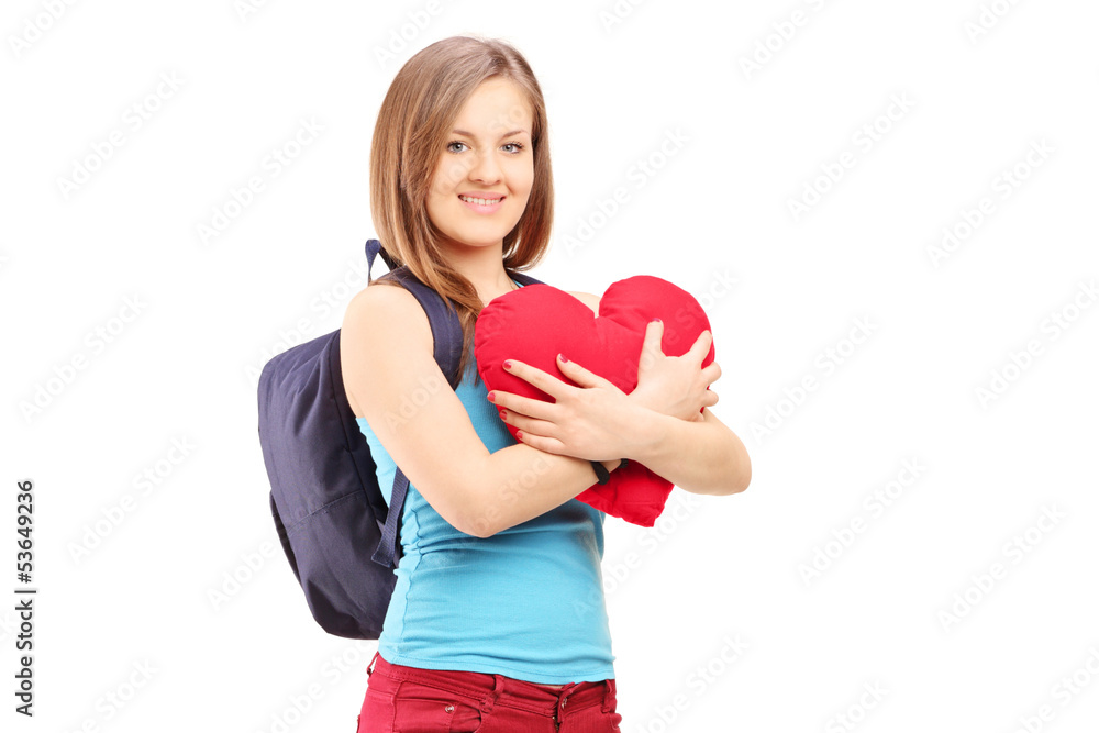 Female student with backpack holding a red heart Female student with backpack holding a red heart