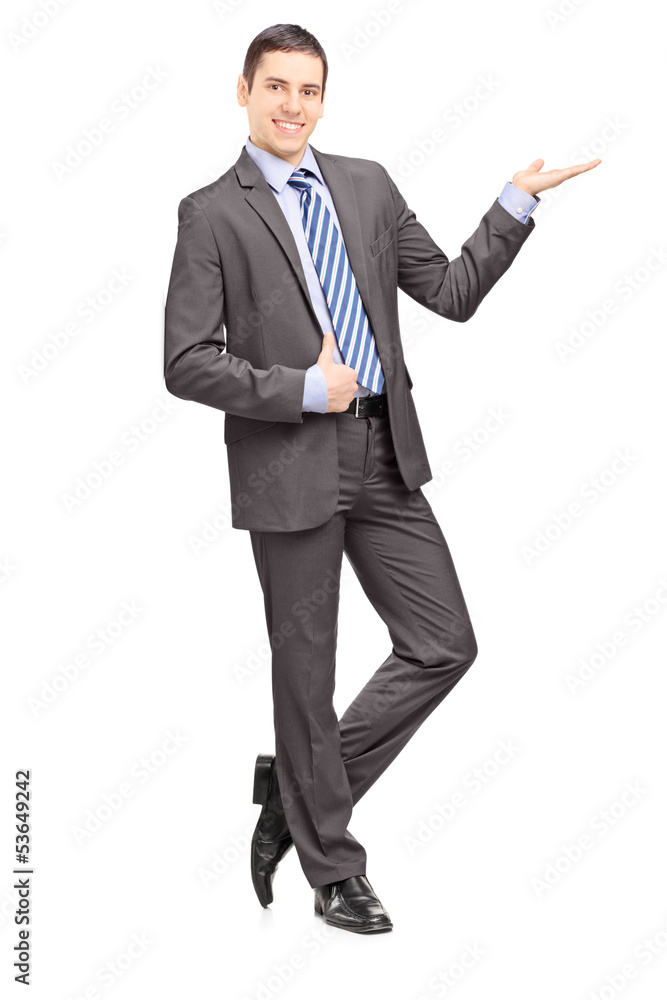 Full length portrait of a young businessman leaning against wall Full length portrait of a young businessman leaning against wall