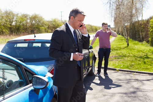 Businessman Making Phone Call After Traffic Accident