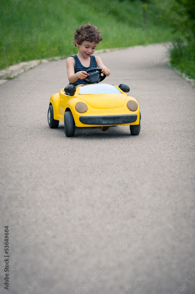 Young kid playing with toy car outdoors with copy space. Young kid playing with toy car outdoors with copy space.