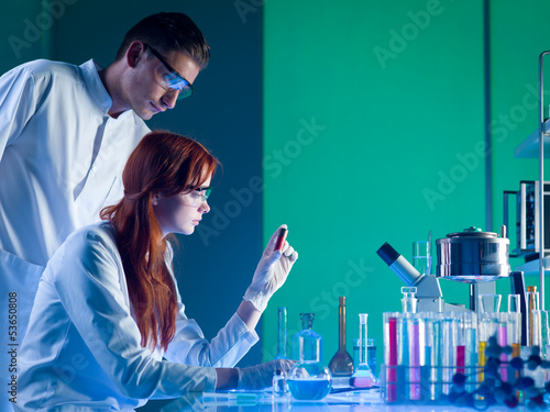 forensic scientists studying a cartridge photo