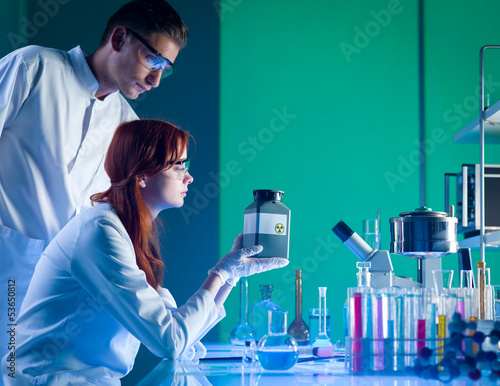 scientists with toxic waste container photo