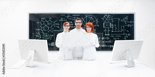 Three lab technicians dressed in white photo