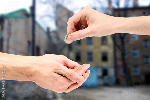Hand gives coin to beggar on the street © ronstik
