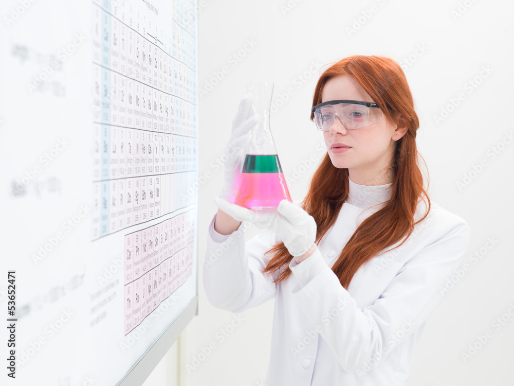 female chemist holding flask female chemist holding flask