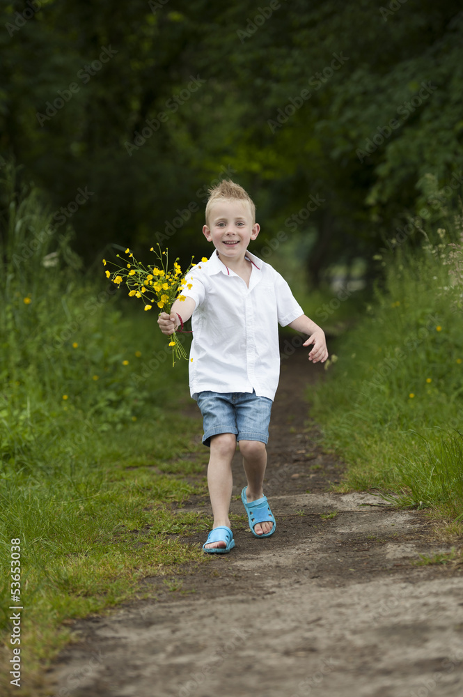 Mother's day : little boy with flowers , outdoors Mother's day : little boy with flowers , outdoors