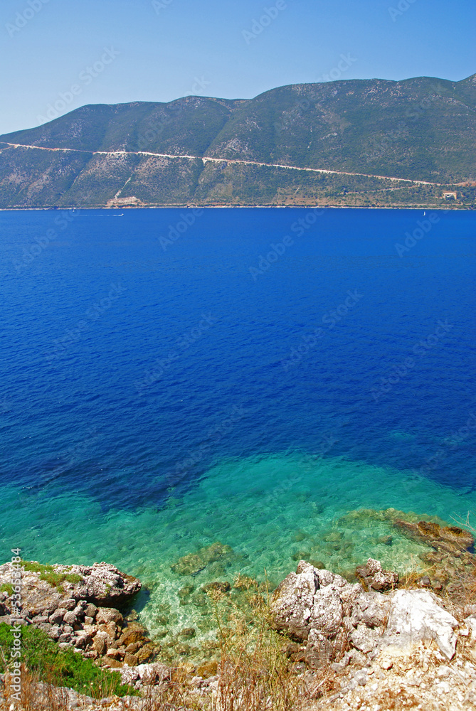 View of the blue sea, shore and horizon in the background