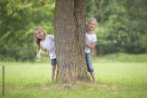little girls playing hide and seek