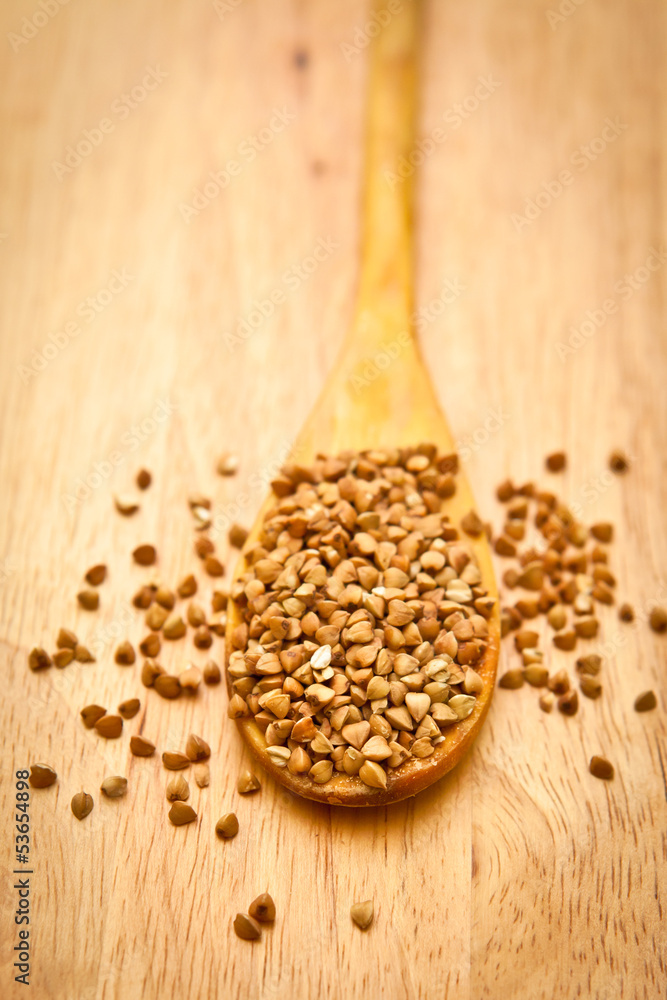 Buckwheat on a wooden spoon