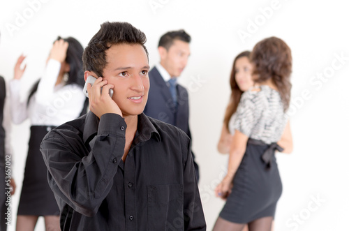Businessman using a cellphone with peers