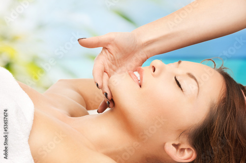 woman on resort getting face spa treatment