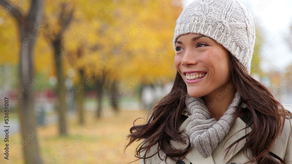 Fall woman looking to side then waving hello Fall woman looking to side then waving hello
