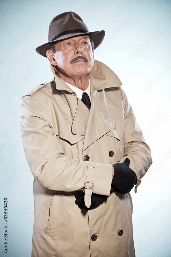 Vintage detective man with mustache and hat. Wearing raincoat. S Stock-Foto  | Adobe Stock