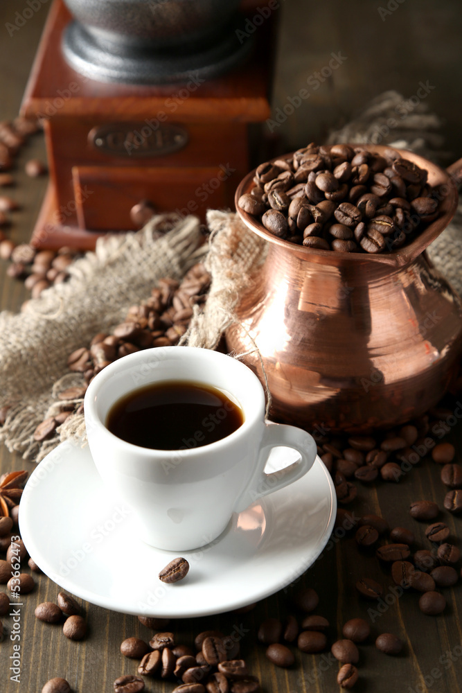 Cup of coffee, pot and grinder on wooden background Cup of coffee, pot and grinder on wooden background