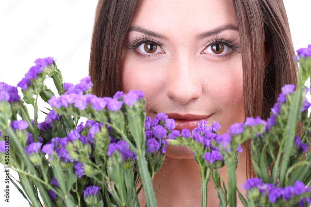 Beautiful young woman with flowers isolated on white Beautiful young woman with flowers isolated on white
